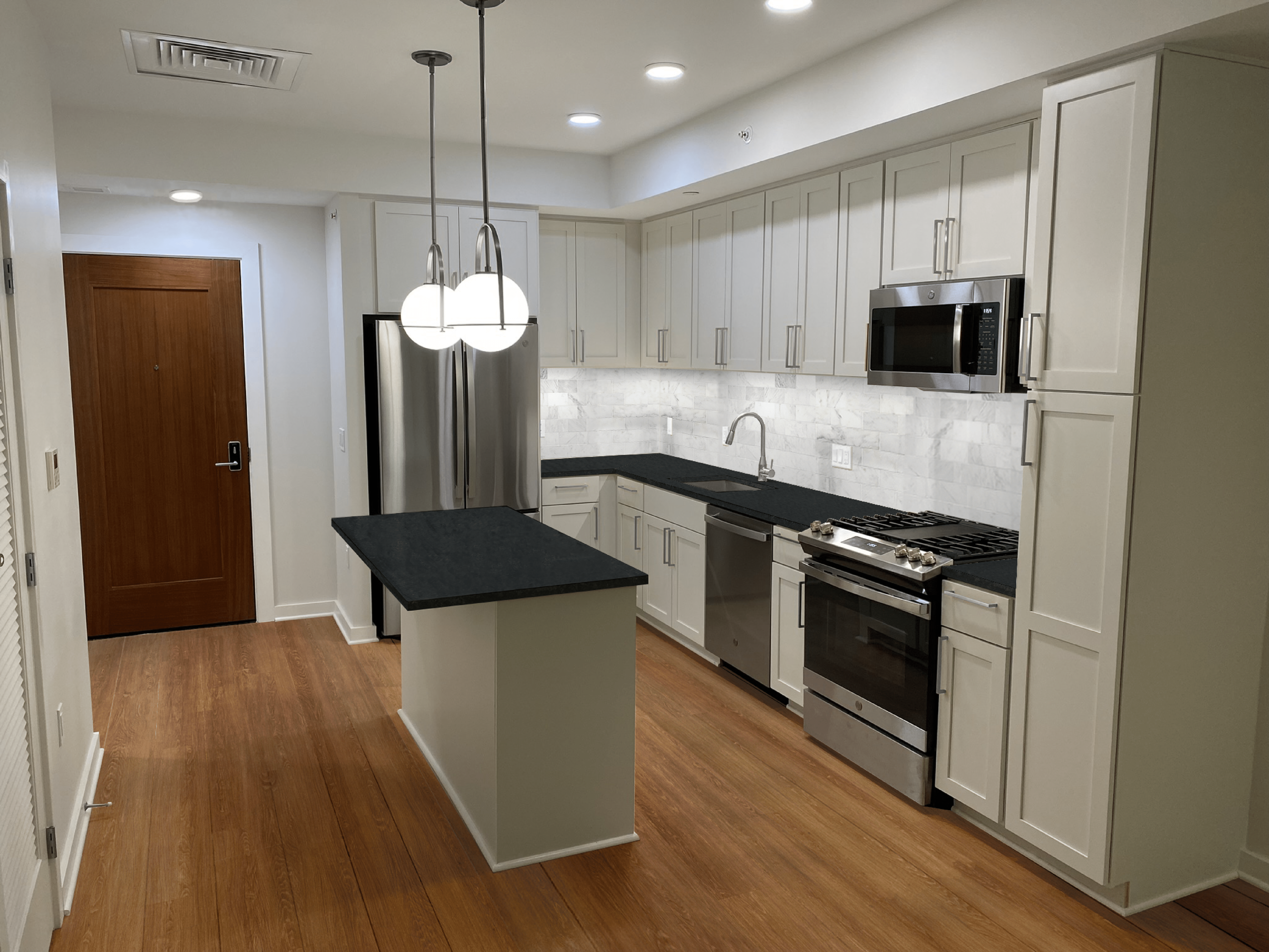 The Milton kitchen with white cabinets and black countertops